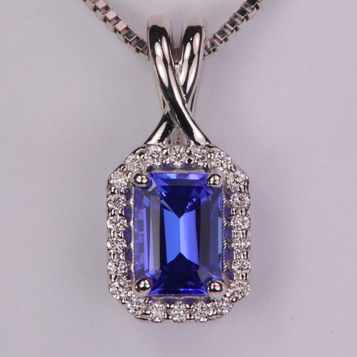 emerald cut tanzanite gemstone pendant in white gold with diamond halo
