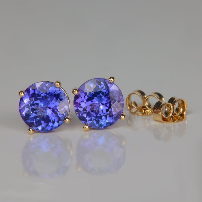 blue violet tanzanite gemstone stud earrings in yellow gold