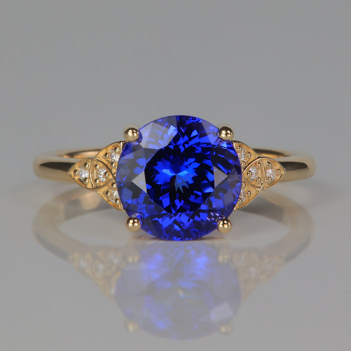 round brilliant violet blue tanzanite and diamond ring in yellow gold