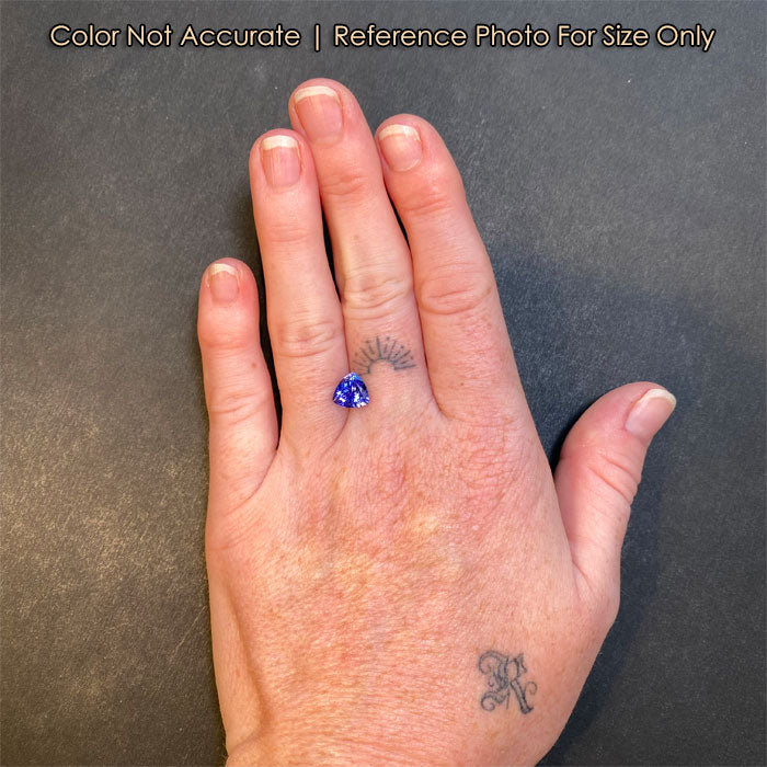 size of trilliant tanzanite gem to a hand