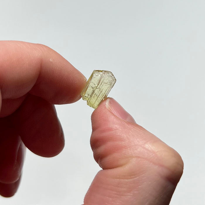 greenish yellow natural tanzanite size in a hand
