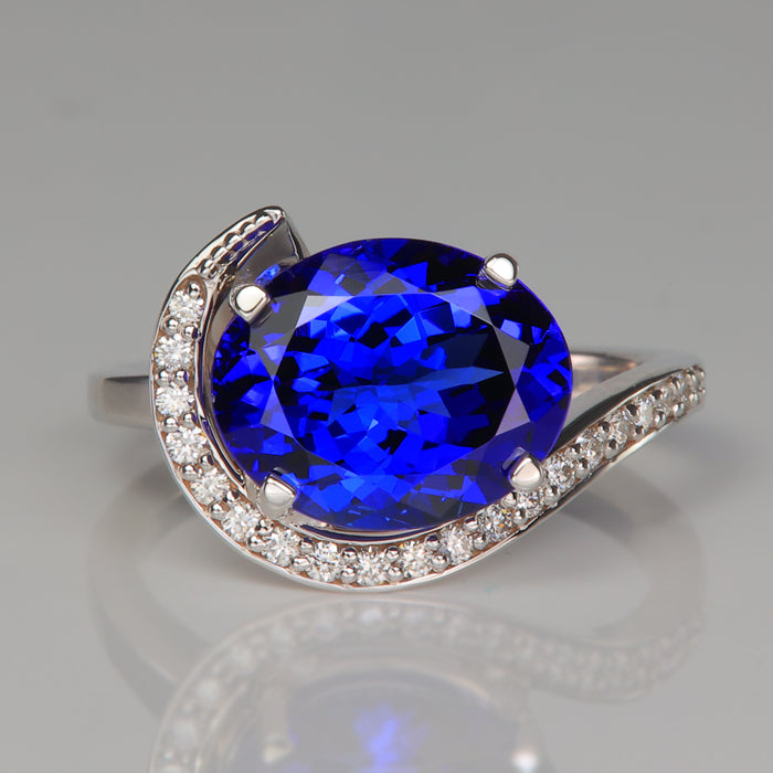 mostly blue oval cut tanzanite gemstone ring with diamonds in white gold