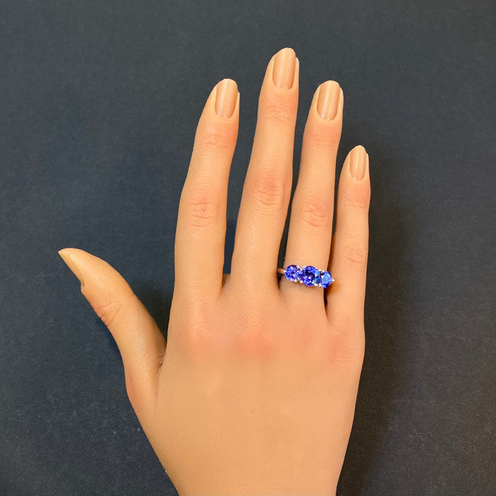 trio of round brilliant tanzanites ring
