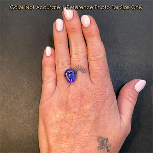 tanzanite gemstone shield cut on hand 