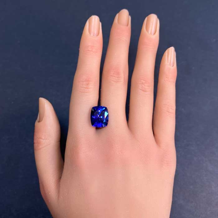antique cushion cut tanzanite on hand