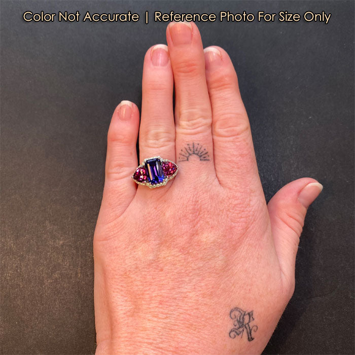white gold tanzanite and garnet ring on hand