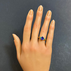 oval cut tanzanite yellow gold ring with emeralds