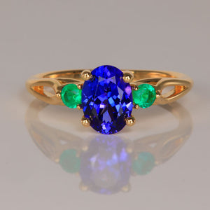 oval cut tanzanite and round emeralds yellow gold ring