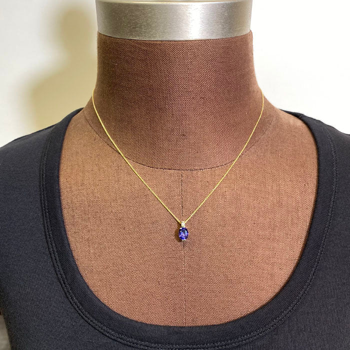 oval tanzanite pendant single diamond accent yellow gold