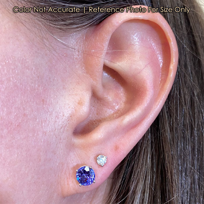 tanzanite stud earrings on ear round brilliant