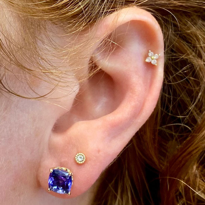 tanzanite and yellow gold studs on ear