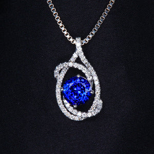 White Gold Tanzanite and Diamond Swirl Pendant